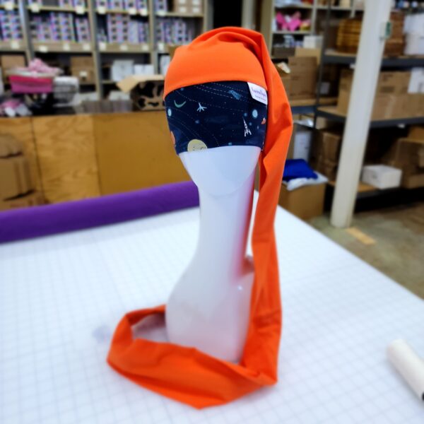 Orange NillyNoggin EEG Cap with Navy Planets and Solar System design showing full length on a mannequin head