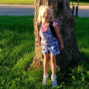 girl standing by tree