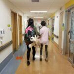 mom and daughter walking in emergency room at hospital