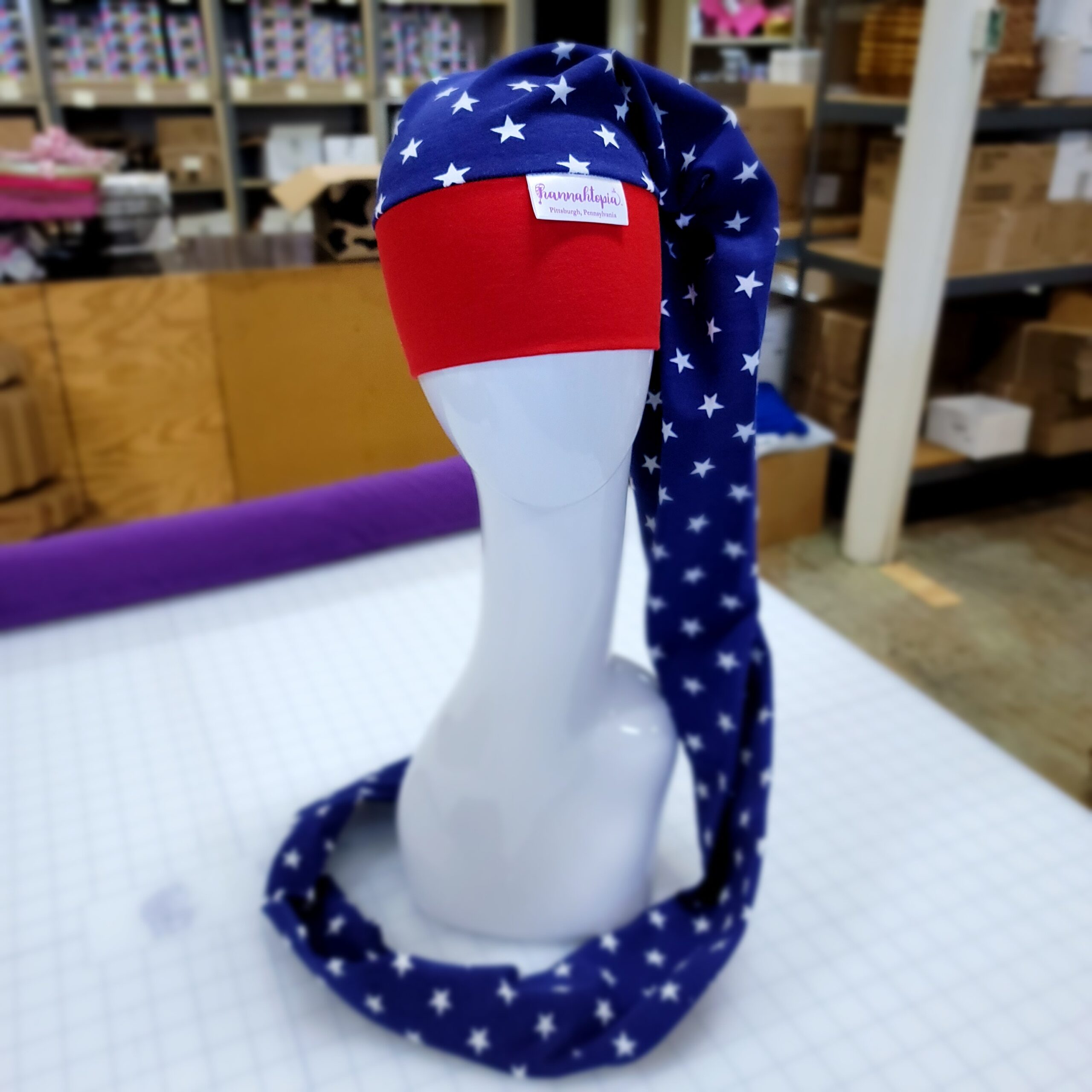 Red and Blue NillyNoggin EEG Cap with White Stars showing full length on a mannequin head