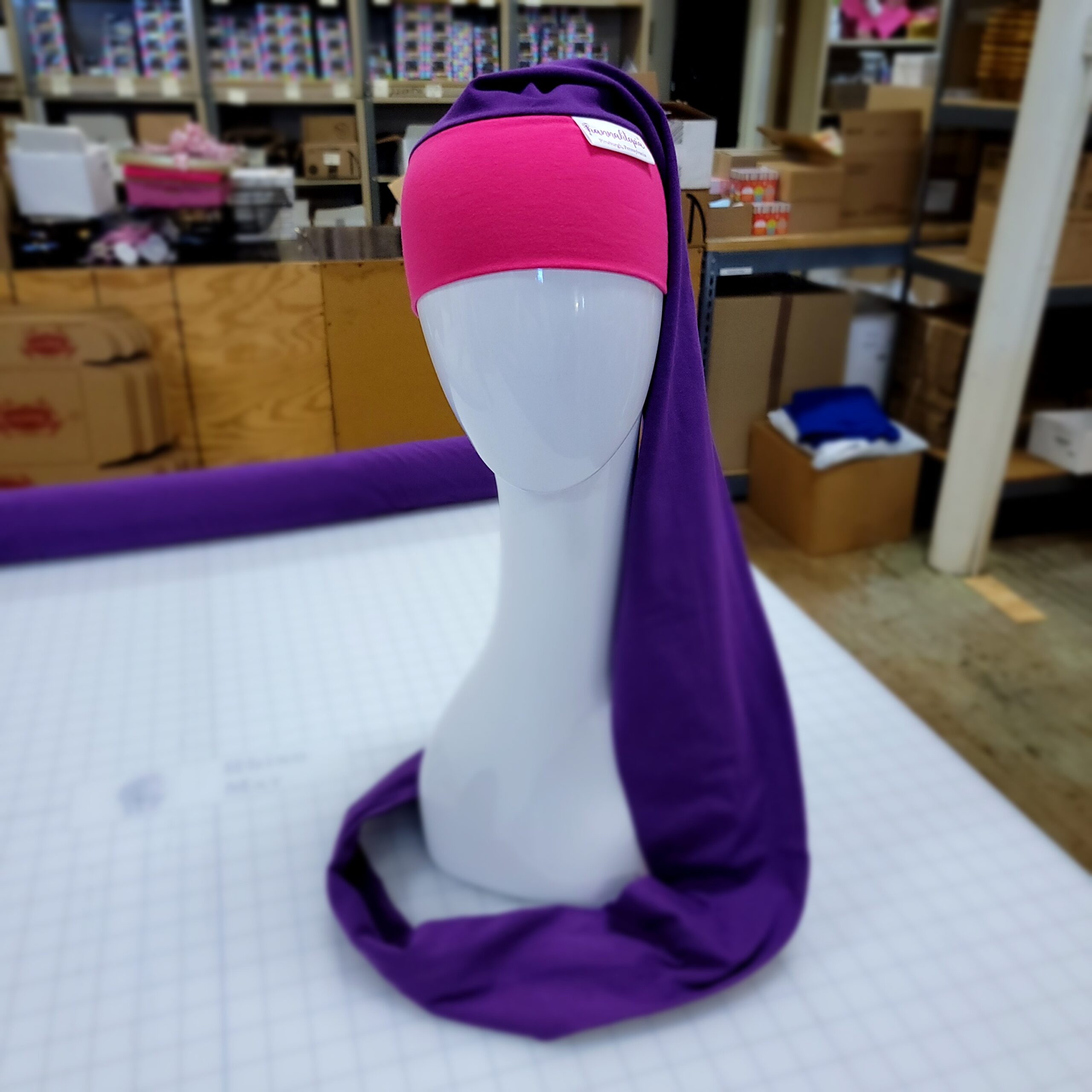 Hot Pink and Purple NillyNoggin EEG Cap showing full cap on mannequin head