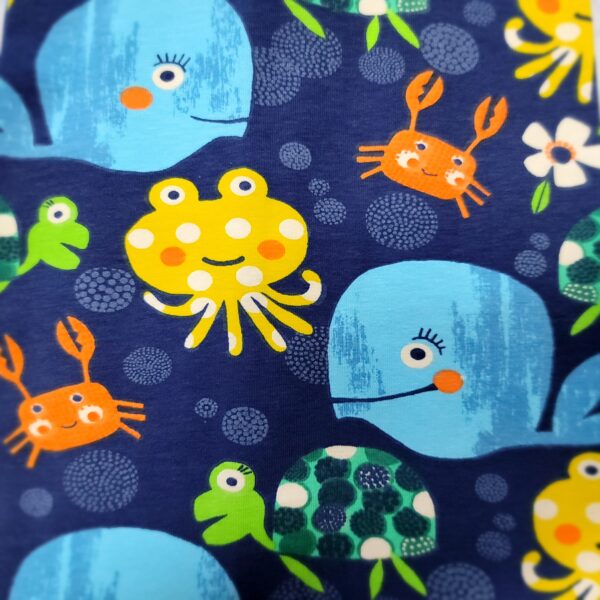 navy fabric with blue whales, yellow octopus, orange crab and green turtles